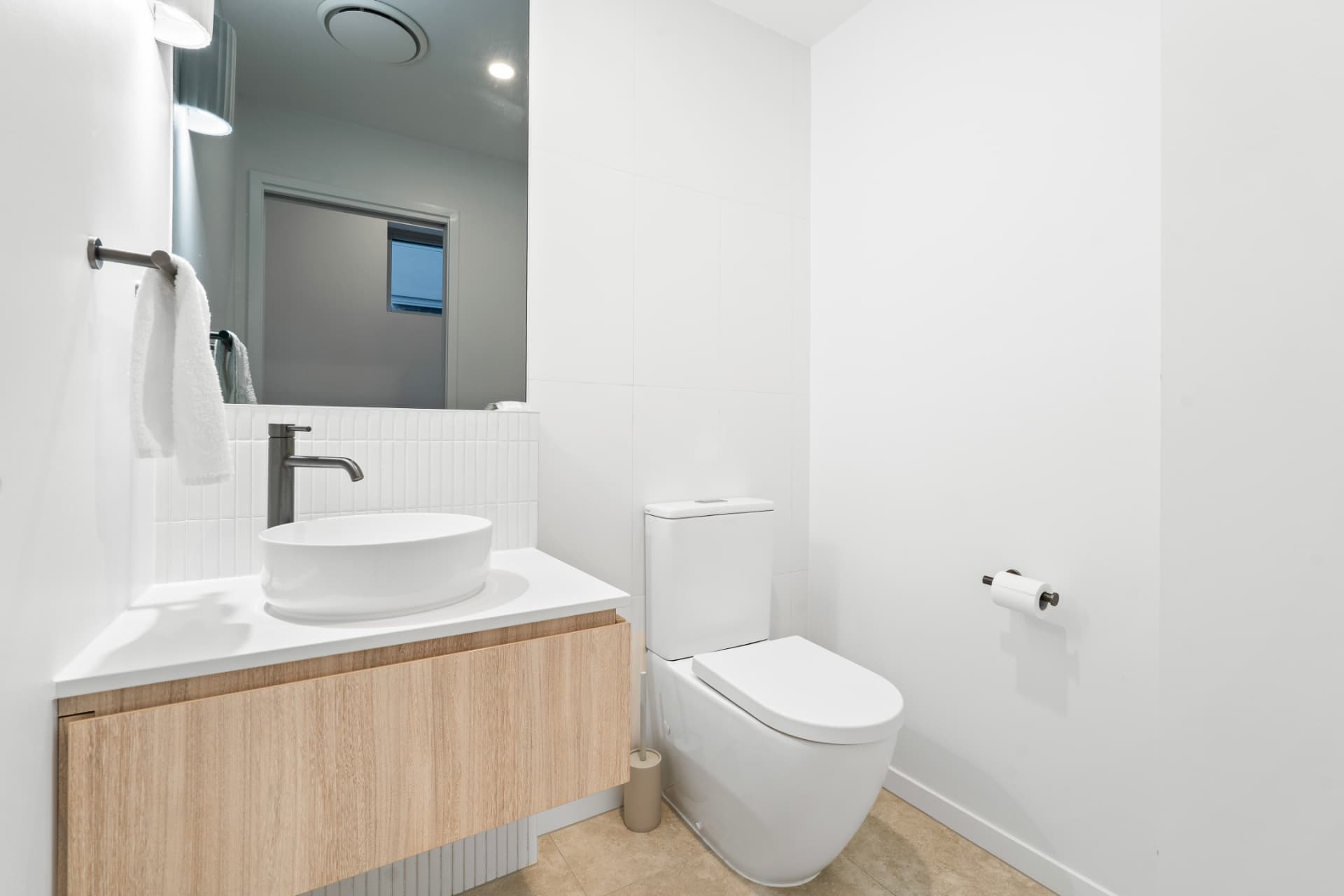 Minimal bathroom with vessel basin and timber vanity