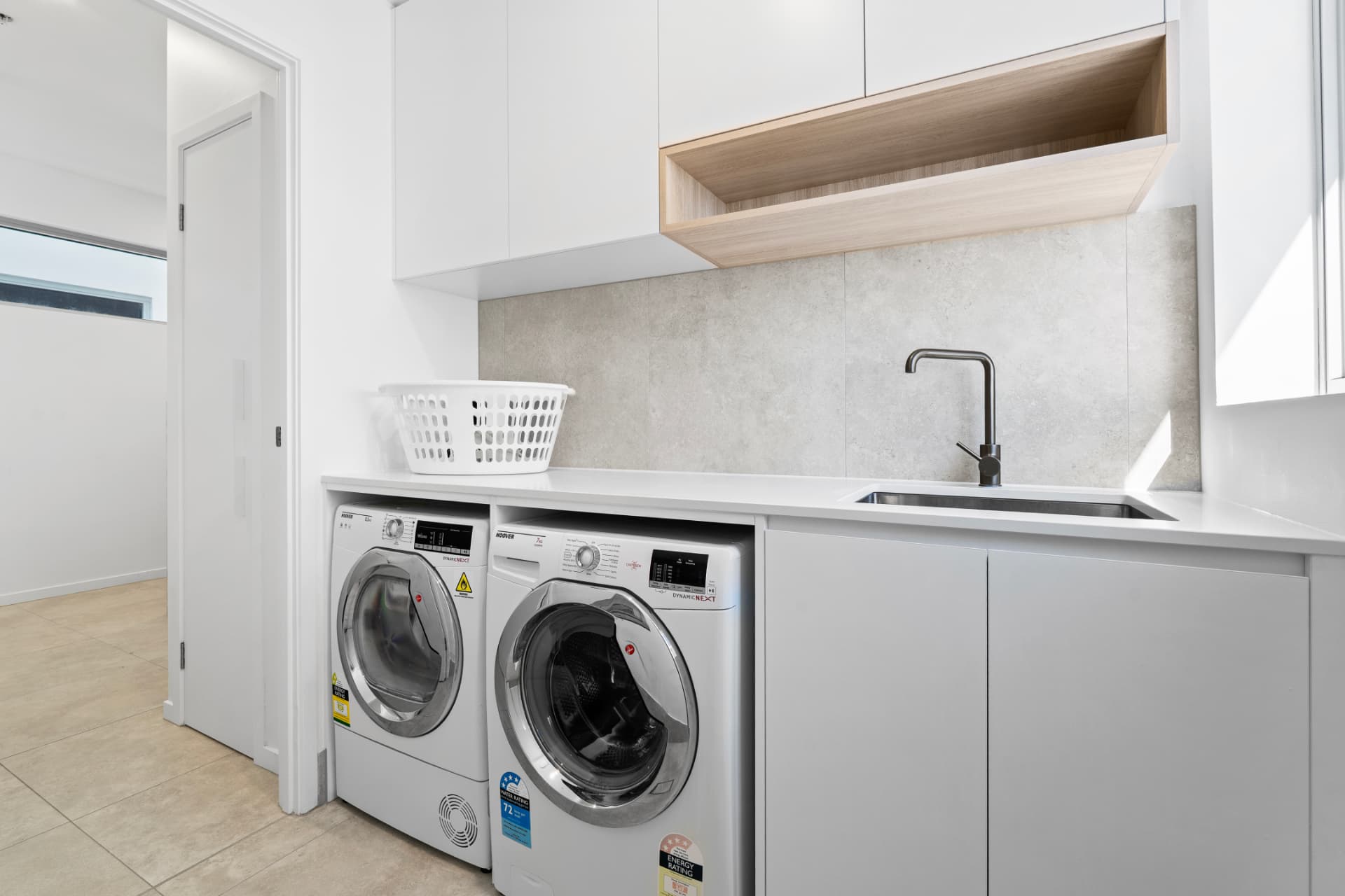 Private internal laundry with washer, dryer and stone benchtop