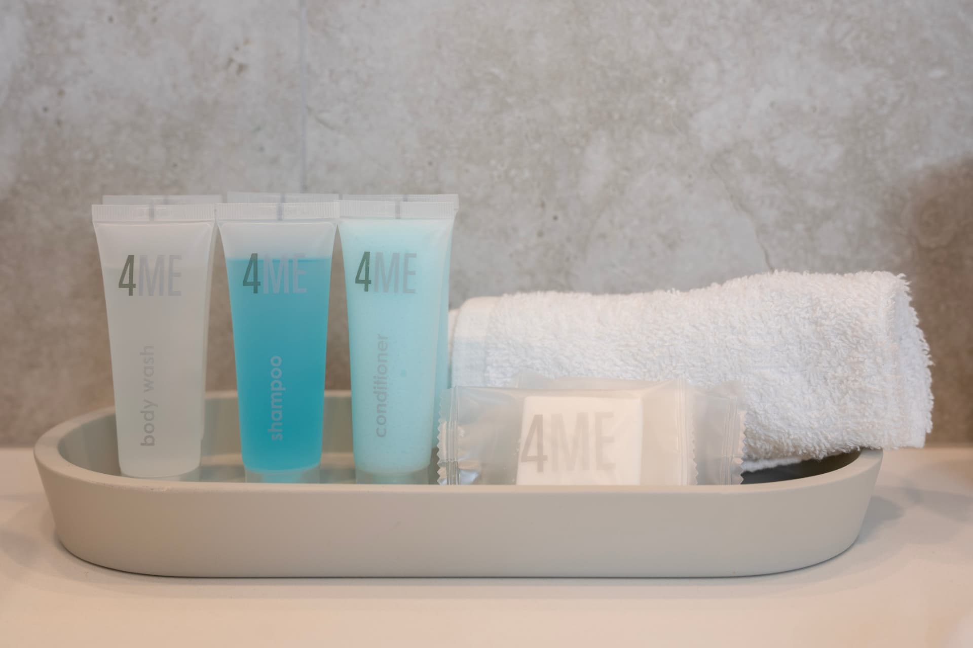 Bathroom amenities tray with towels and toiletries